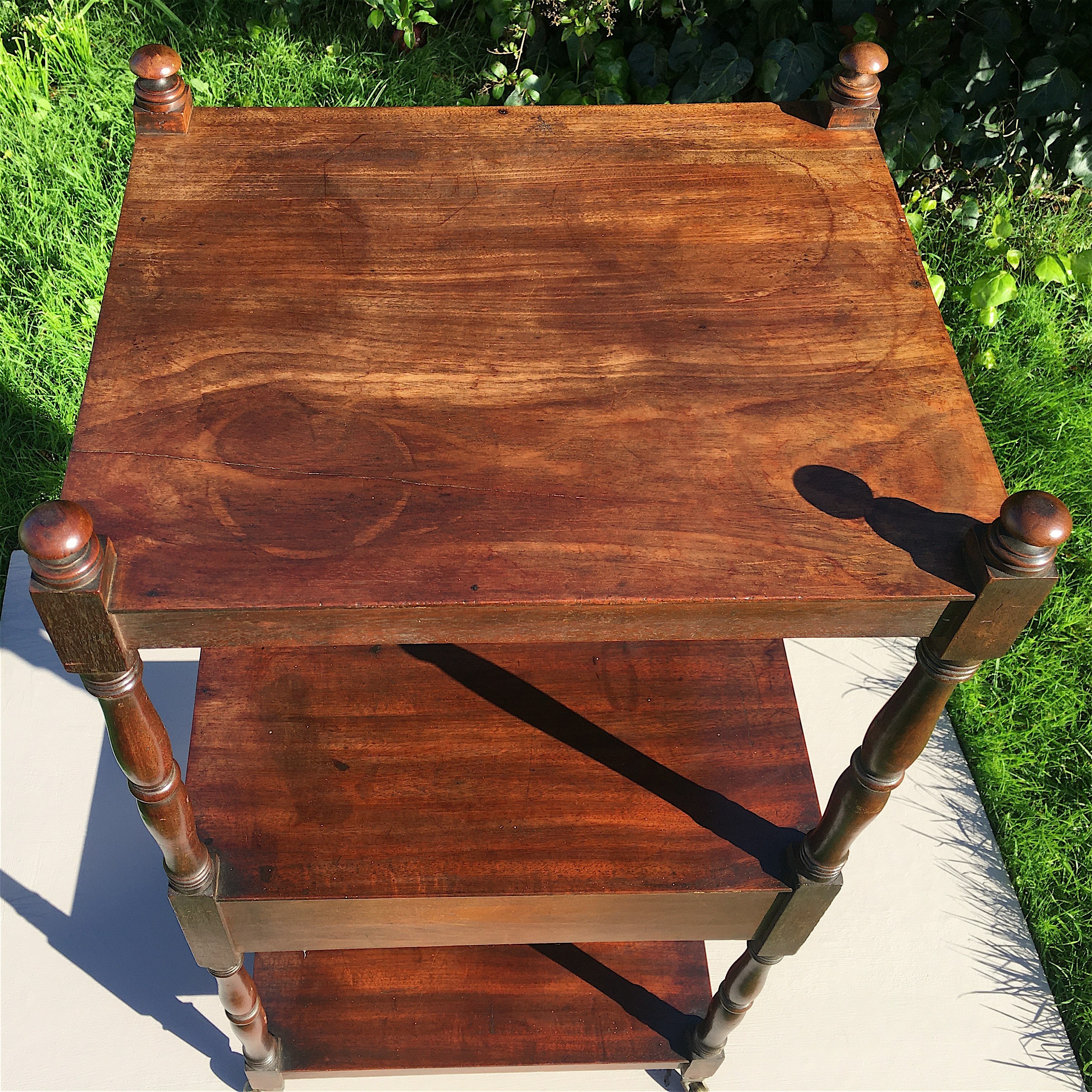 A Regency mahogany three tier whatnot fitted mid drawer, width 46cm, depth 38cm, height 98cm.